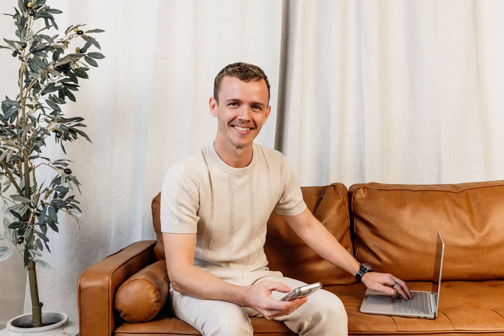 Jayden from Loom Digital working beside a laptop